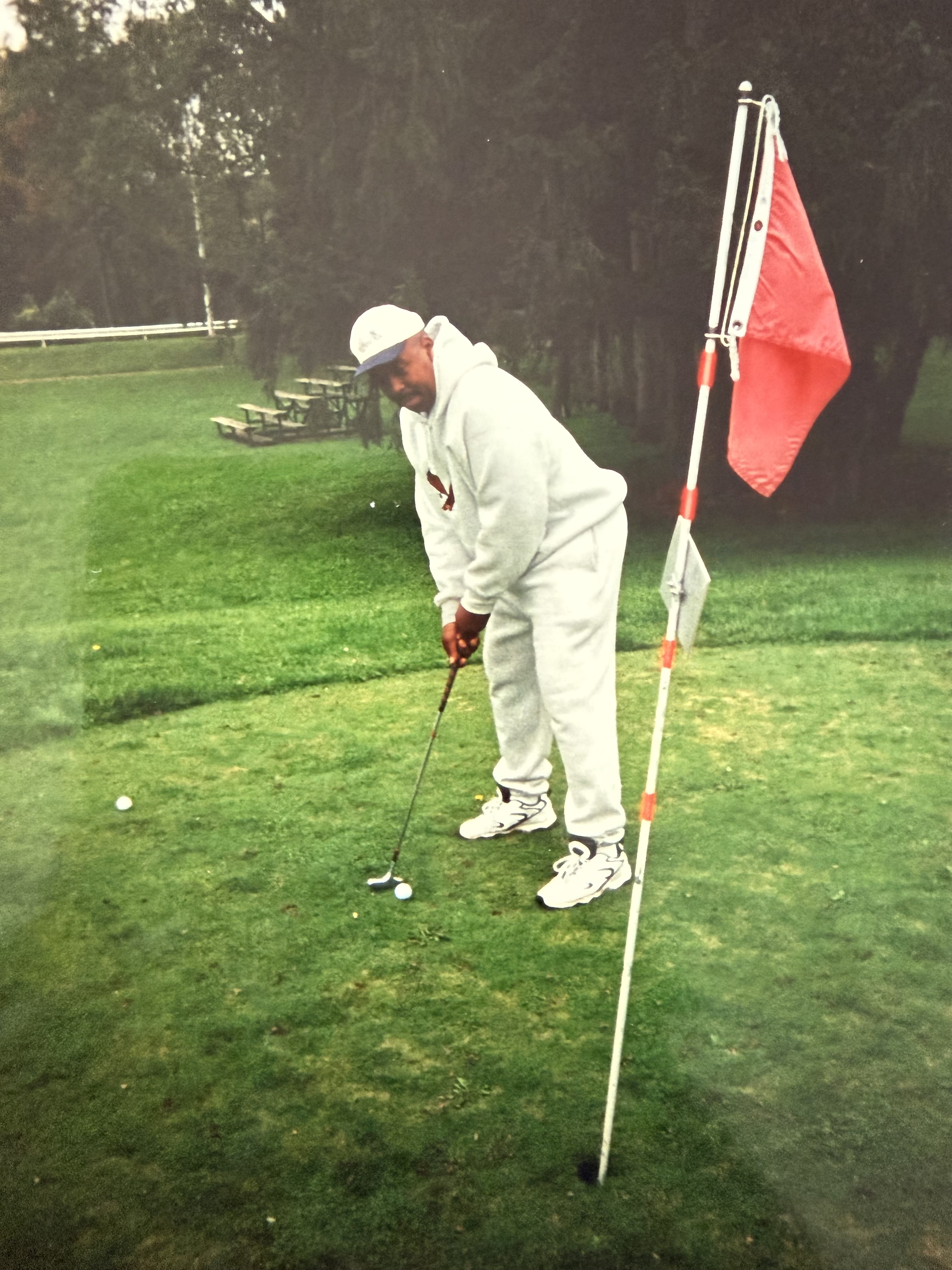 Raymond golfing on a green
