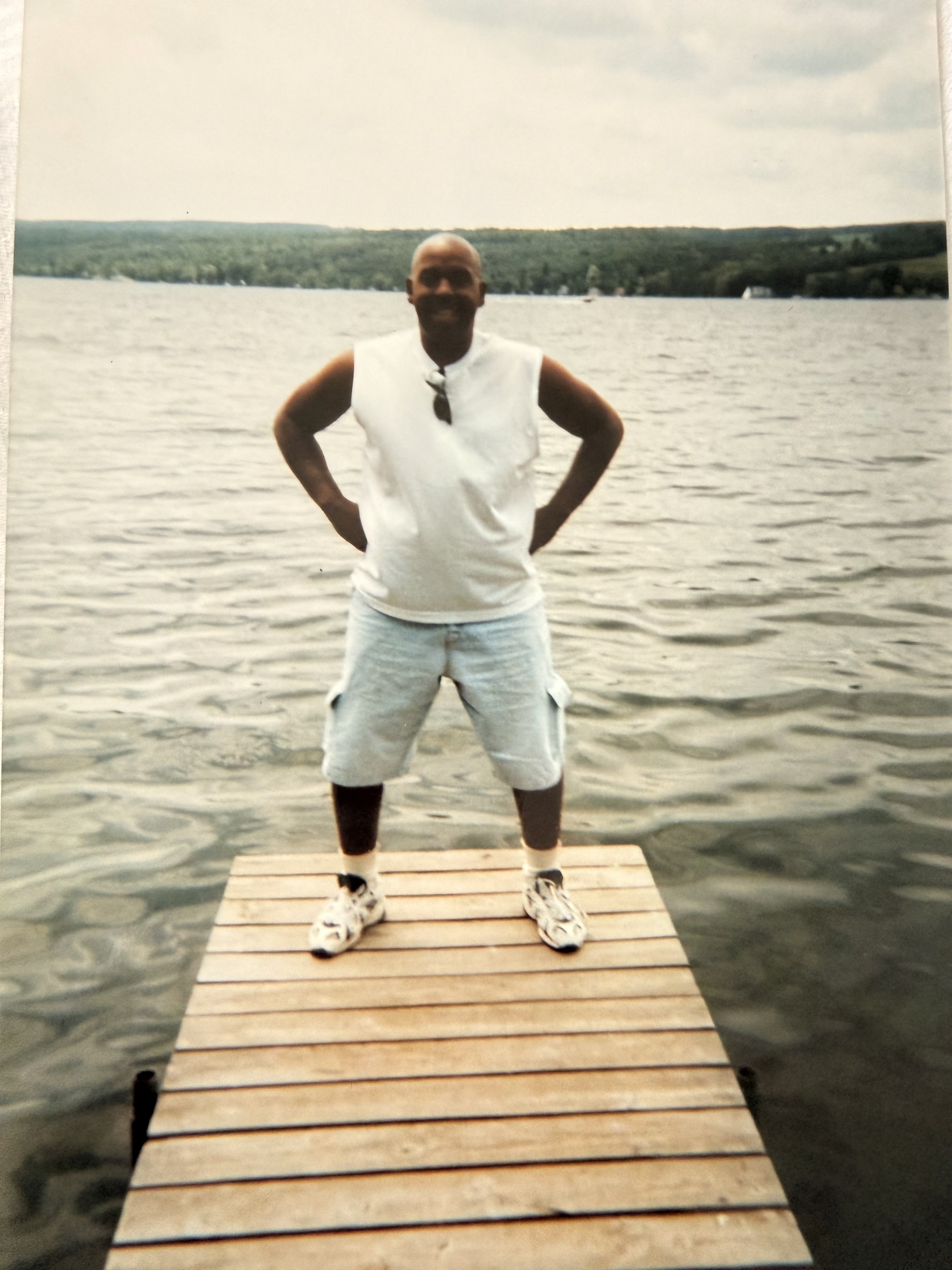 Raymond standing on a dock by the water