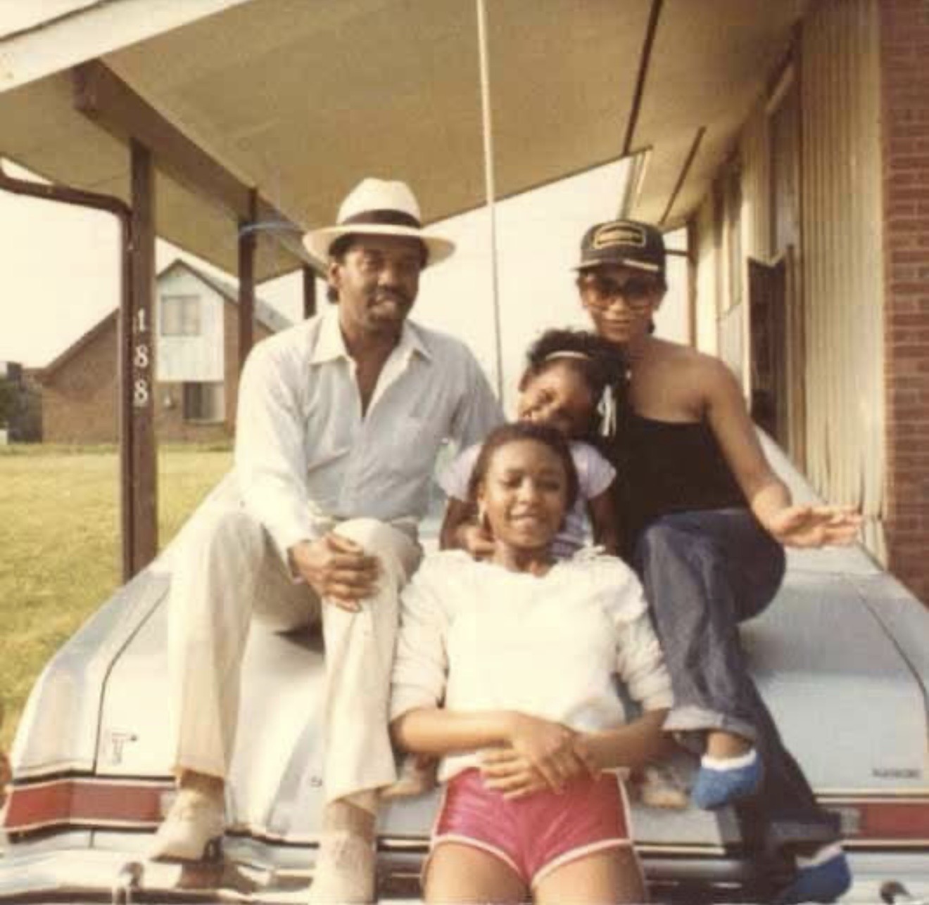 Raymond with family members gathered on a car